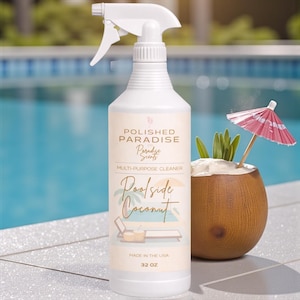May include: A white spray bottle of "Polished Paradise" multi-purpose cleaner, "Poolside Coconut" scent. The bottle is 32 oz and has a label with a beach scene. A coconut drink with a red umbrella is next to the bottle.