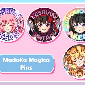 May include: Five circular Madoka Magica pins with anime-style illustrations and text. The pins feature phrases such as "LESBIAN JESUS", "LESBIAN SATAN", "HOMO-RA AKEMI", and "SO, NO HEAD?". The background is a soft pink colour.