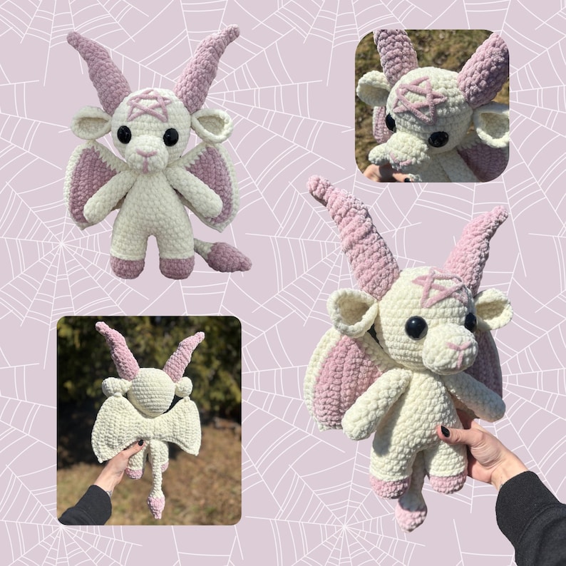 May include: A white crocheted plush toy with pink wings and horns. The toy has a pentagram on its forehead and black eyes. The toy is being held by a hand.