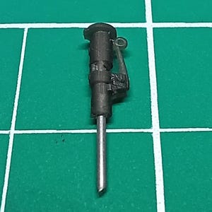 May include: A black and silver jackhammer tool with a metal handle and a silver drill bit.