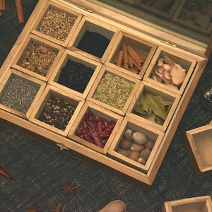 May include: A wooden box with 12 compartments filled with various spices and herbs. The box is open and the compartments are filled with different spices, including black peppercorns, cloves, cinnamon sticks, and bay leaves.