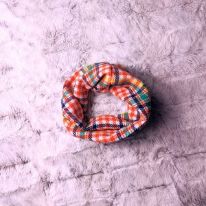 A simple scarf that slips over your pets head. A fashion statement. Many colors to choose from. This is a vintage bright orange and blue and green plaid pattern.