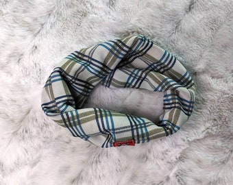 May include: A white, blue and green plaid neck warmer. The neck warmer is made from a soft, stretchy fabric and is ideal for keeping warm in the winter.