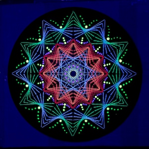 May include: A colourful string art mandala with a black background. The mandala is made with red, blue, green, and purple string. The string is arranged in a geometric pattern with a central star shape.