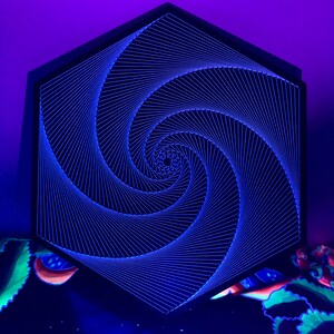 May include: A black hexagonal frame with a blue and white string art design of a spiral. The spiral is made of thin strings that are tightly woven together to create a 3D effect.