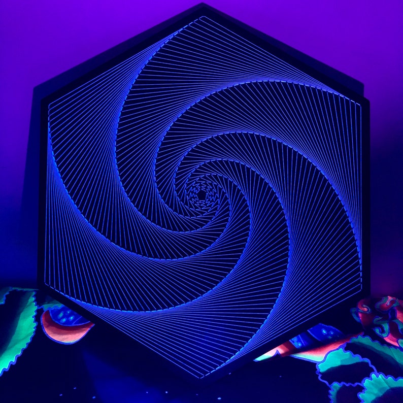 May include: A black hexagonal frame with a blue and white string art design of a spiral. The spiral is made of thin strings that are tightly woven together to create a 3D effect.