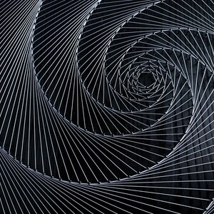 May include: A black background with a silver wire spiral design. The wire is woven in a circular pattern, creating a hypnotic effect.