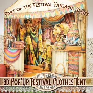 May include: A 3D pop-up paper art piece titled "Part of the Festival Fantasia Series" featuring a clothes tent. The artwork showcases two figures, clothing, baskets, and decorative items. The color palette includes warm tones of yellow, orange, and green.