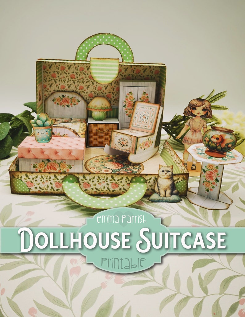 May include: A printable dollhouse suitcase with a green and white floral pattern. The suitcase is open and reveals a miniature bedroom with a bed, rocking chair, and a lamp. There is a small cat sitting on a pillow in the suitcase. The text "Emma Parrish Dollhouse Suitcase Printable" is on the front of the suitcase.
