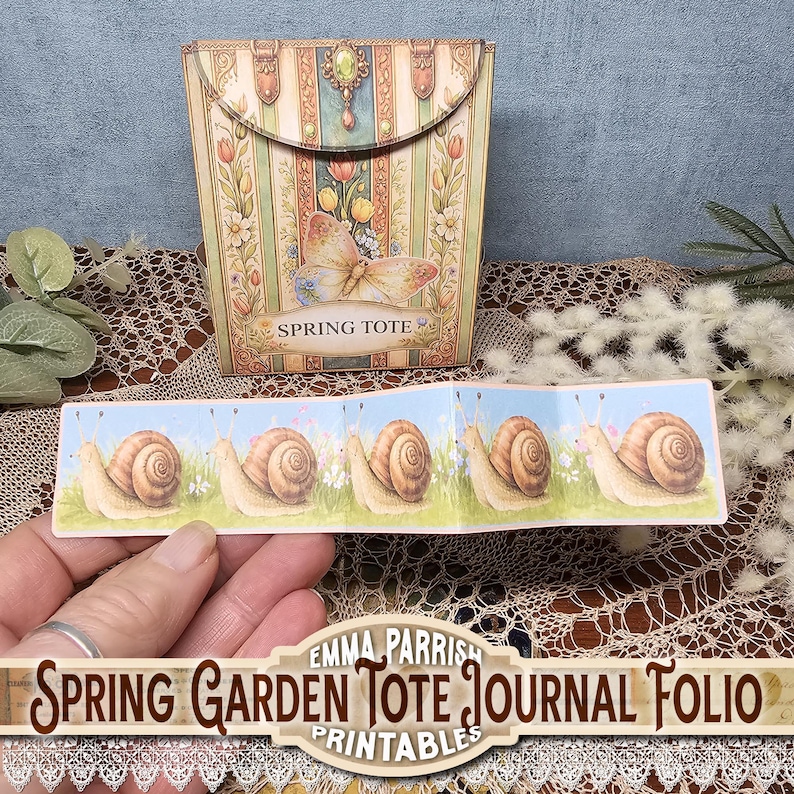 May include: A decorative spring-themed journal folio with a matching tote. The tote features a butterfly and floral design with the words "Spring Tote". The journal folio has a repeating pattern of snails on a blue background with grass and flowers.