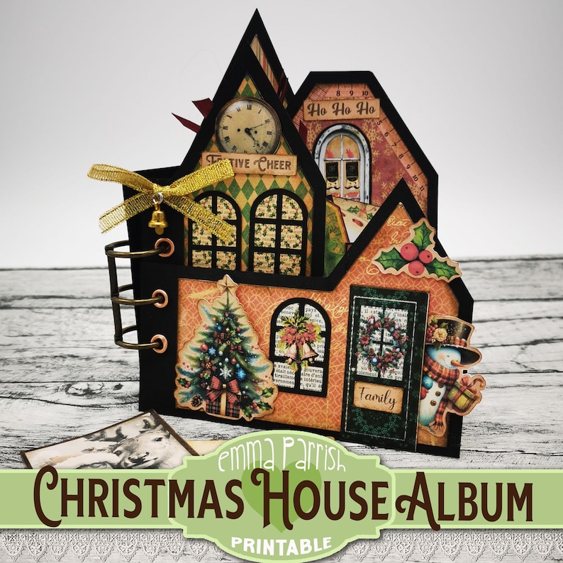 May include: A printable Christmas house album with a festive design. The album is decorated with a Christmas tree, a snowman, and a wreath. The album is titled "Christmas House Album" and has the text "Emma Parrish" and "Printable" on it.