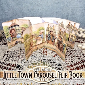 May include: A multi-paneled accordion-style flip book featuring illustrated scenes of a small town. The panels display various characters including a person with a basket, a baker with pastries, a violinist, and a person with a dog, set against houses.