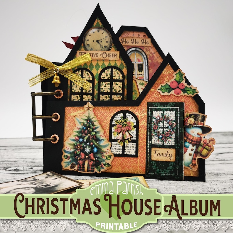 May include: A printable Christmas house album with a festive design. The album features a red and green Christmas tree, a snowman, and a wreath. The front of the album has the text "TIVE CHEER" and "Ho Ho Ho" on it. The album is decorated with gold ribbon and a bell.