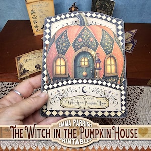May include: A decorative paper craft featuring a pumpkin-shaped house with a central door, two windows, and a lantern. The design includes a black and white diamond border, floral accents, and the text The Witch in the Pumpkin House.