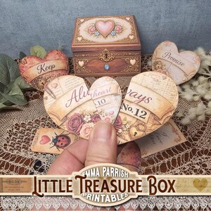 May include: A wooden treasure box with a heart design, surrounded by heart-shaped cards with text and floral accents. The cards read "Keep," "Promise," and "Always." A hand holds a broken heart card. The image includes the text "Little Treasure Box Printables."