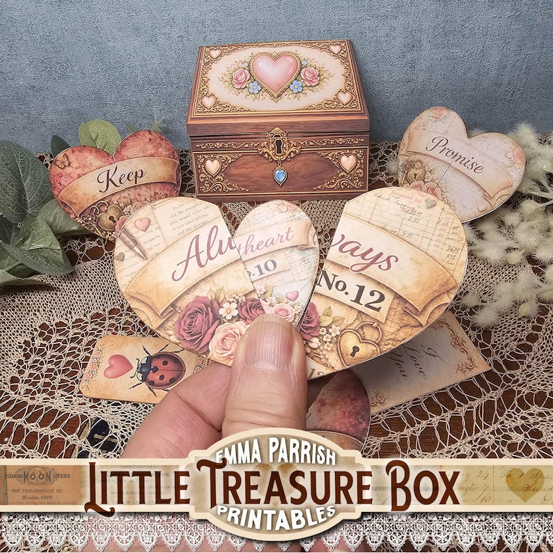 May include: A wooden treasure box with a heart design, surrounded by heart-shaped cards with text and floral accents. The cards read "Keep," "Promise," and "Always." A hand holds a broken heart card. The image includes the text "Little Treasure Box Printables."