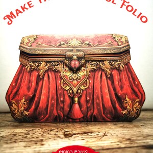 K&ouml;nnte beinhalten: Eine verzierte Schachtel in Rot und Gold mit einem Quasten, die an eine Vintage-Handtasche erinnert, mit dem Text "MAKE THIS BEAUTIFUL FOLIO" dar&uuml;ber und "emma Parrish MAGIC! Journaling Folio" unterhalb der Schachtel.