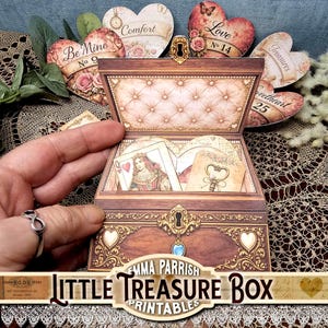 May include: A paper craft treasure box featuring a wood-grain finish, gold filigree accents, and a central keyhole design. The open lid reveals a tufted interior, while the box contains a Queen of Hearts playing card and a decorative key tag.