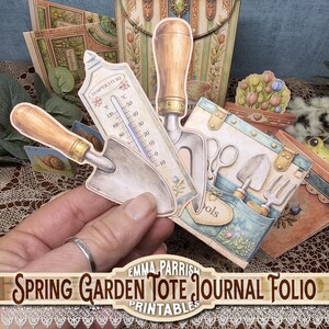 May include: A collection of paper garden-themed ephemera, including a thermometer, trowels, and a journal folio. The thermometer displays both Fahrenheit and Celsius scales. The text "Spring Garden Tote Journal Folio Printables" is visible.