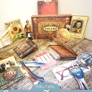 May include: A printable set of vintage-style images, including a cigar box, a tobacco tin, a pocket watch, a photo frame, a pair of glasses, a key, a pocket knife, a dog tag, a pack of seeds, and a book. The images are labeled with the text "CIGARS", "TOBACCO", "Free My Love", "MAX", "SFEDS", and "THE SECRET".