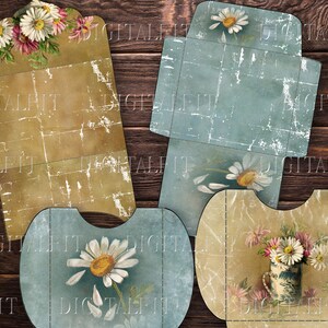 May include: Four printable vintage style gift card envelopes with floral designs. The envelopes are in shades of blue, brown, and white. The envelopes are decorated with daisies and other flowers.