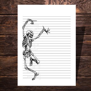 May include: A black and white line drawing of a skeleton dancing on a white sheet of lined paper.