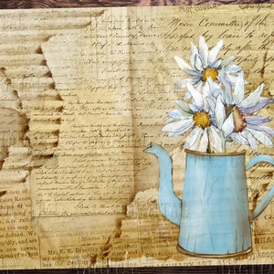 May include: A vintage blue metal watering can with a rustic wooden background. The can is filled with white daisies with yellow centers. The background is a collage of old, faded paper with handwritten text.