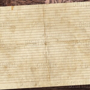 May include: A vintage, lined paper sheet with a worn, aged appearance. The paper is folded in half and has a brown wood background.