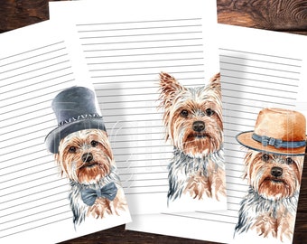 May include: Three printable lined stationery sheets featuring watercolour illustrations of Yorkshire Terriers. Each dog is wearing a different hat, one with a blue bow tie, one with a brown hat, and one with a grey top hat.
