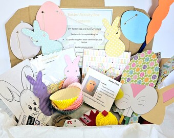 May include: A white box filled with craft supplies for an Easter activity box. The box includes paper cutouts of bunnies, eggs, and carrots, cupcake liners, yarn, and a chick craft kit. The box also includes instructions for making Easter crafts.