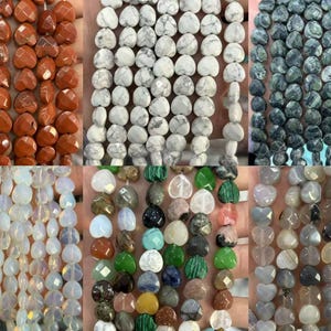 May include: Assortment of heart-shaped gemstone beads in various colors, including orange, white, green, and gray. The beads are strung together, showcasing their faceted surfaces and natural variations. Ideal for jewelry making.