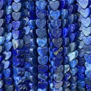 May include: A strand of heart-shaped lapis lazuli beads. The beads are a deep blue colour with white veins running through them.