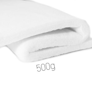 Könnte beinhalten: Ein weißer, gefalteter, weicher, flauschiger Stoff mit dem Text "500g" darunter.