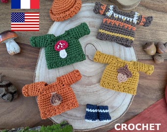 May include: Crochet pattern for four miniature sweaters with autumnal themes. The sweaters feature a mushroom, acorn, and geometric designs in shades of green, brown, orange, and yellow. The pattern also includes a pair of miniature boots.
