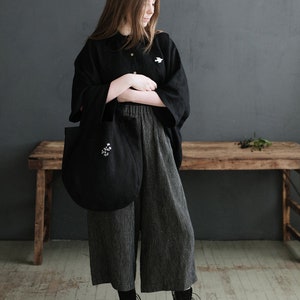 a woman standing in front of a wooden bench