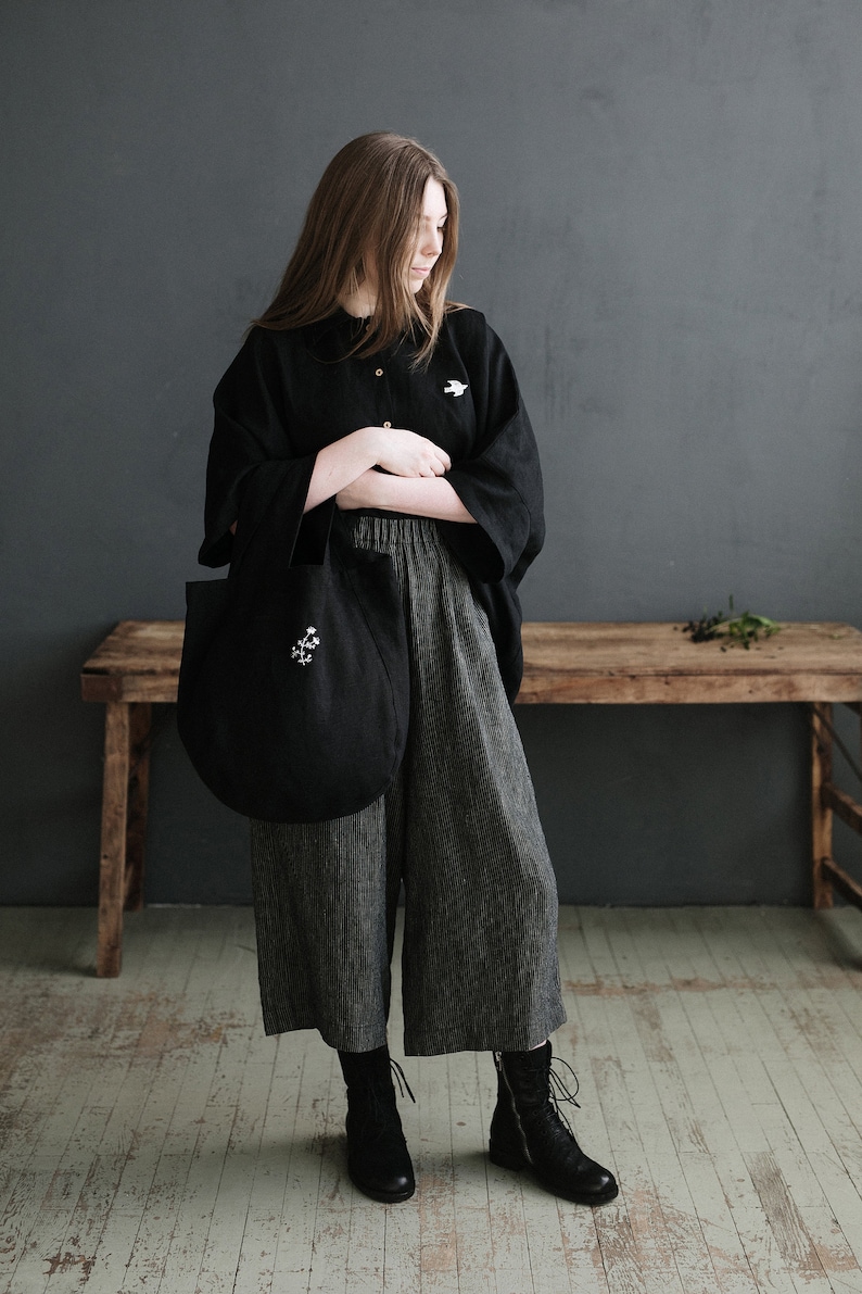 a woman standing in front of a wooden bench