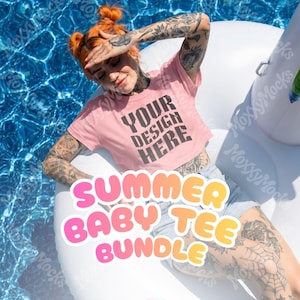 Op de afbeelding: Een roze crop top met de tekst "YOUR DESIGN HERE" is afgebeeld. De woorden "SUMMER BABY TEE BUNDLE" zijn ook zichtbaar. De top wordt gedragen op een witte opblaasbare zwemband in een zwembad.