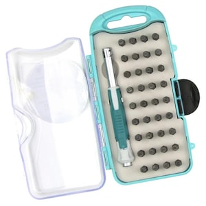 May include: A light blue plastic storage case containing a metal stamping tool with a teal grip and a set of thirty-six individual metal letter and number stamps arranged in a foam insert. The case features a clear hinged lid and a handle.