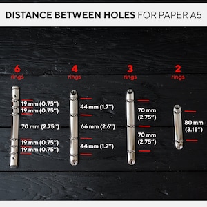 May include: Image showing the distance between holes for A5 paper. Measurements are provided for 6, 4, 3, and 2 ring binders. Measurements are in inches and millimeters.