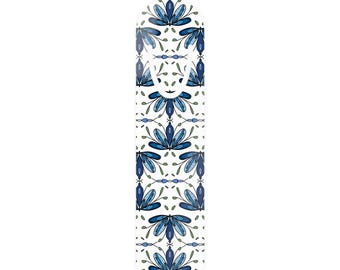 May include: A vertical rectangular bookmark with a rounded top edge, featuring a repeating pattern of stylized blue and light blue floral motifs on a white background, including a die-cut oval opening near the top for page placement.