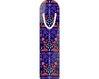 May include: A vertical bookmark with a rounded top and a U-shaped cutout near the top edge. The surface features a repeating pattern of stylized dark purple, light blue, and coral pink floral and leaf shapes against a deep navy blue background.