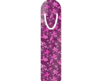 May include: A rectangular bookmark with a rounded top edge, featuring a deep purple background covered in a repeating pattern of small, vibrant pink flowers with white centers and a white U-shaped cutout near the top for page placement.
