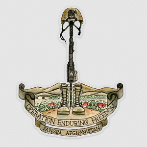May include: A watercolor illustration of a fallen soldier memorial. A rifle, helmet, and boots are arranged in a cross shape. The boots are brown leather and the rifle is black. The helmet is tan and has a green camouflage pattern. The background is a field of green grass and red poppies. The text "Operation Enduring Freedom, Sangin, Afghanistan" is written on a banner.