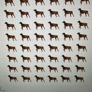 May include: A sheet of brown dog silhouette stickers. The stickers are arranged in a grid pattern on a white background.