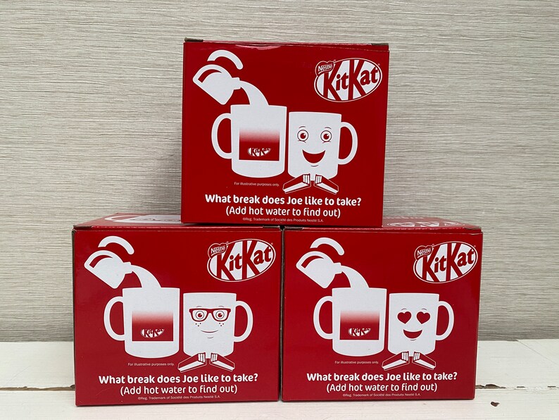 May include: Three red boxes with a white KitKat logo and a white mug on each box. The mugs have different designs: a plain mug, a mug with glasses and a mug with a smiley face. The text on the boxes reads: "What break does Joe like to take? (Add hot water to find out)"