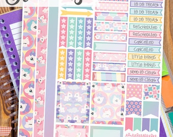 May include: Printable planner stickers featuring a unicorn theme. The stickers include various designs with unicorns, stars, rainbows, and polka dots in pink, purple, blue, and yellow colors. The stickers are labeled with phrases like "To Do Today", "Rescheduled", "Cancelled", and "Little Things".