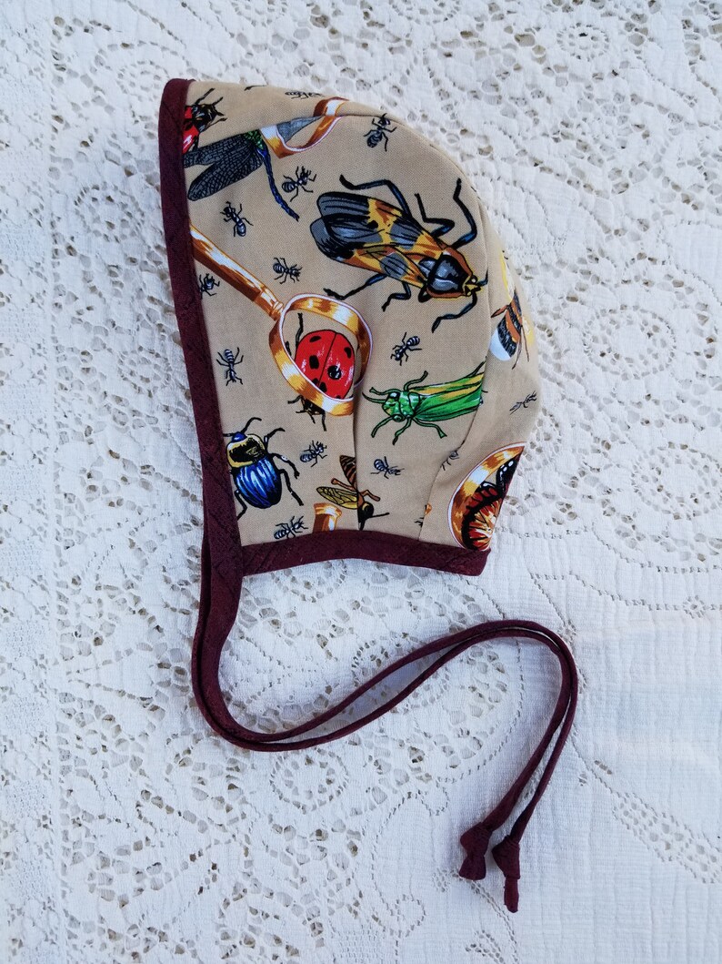 Reversible baby bonnet bugs