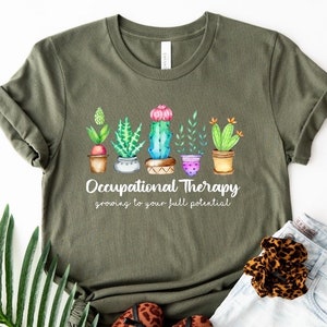 May include: Green t-shirt with a graphic of potted cacti and the text "Occupational Therapy growing to your full potential."