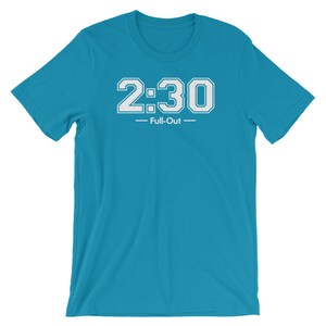Peut inclure: Un t-shirt turquoise avec le texte "2:30 Full-Out" en blanc, en lettres de style bloc. Le texte est centr&eacute; sur la poitrine. Le t-shirt a des manches courtes et un col rond.