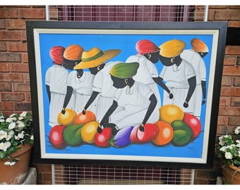 May include: A framed painting depicting a group of figures in white dresses and colorful head coverings, harvesting a variety of fruits and vegetables. The artwork features a vibrant blue background and a black frame, with a brick wall in the background.